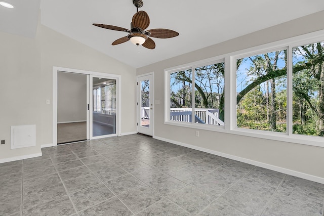 unfurnished sunroom featuring ceiling fan and vaulted ceiling