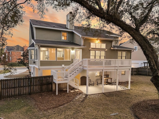 back of property with a patio, fence, a yard, stairway, and a chimney