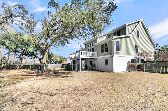 rear view of property with fence, a lawn, a wooden deck, and central air condition unit