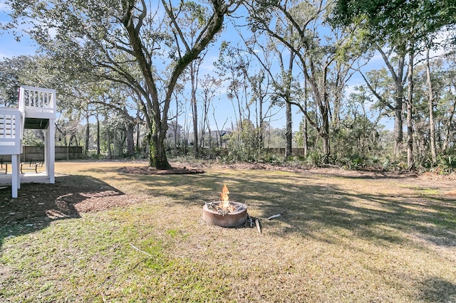 view of yard with a fire pit