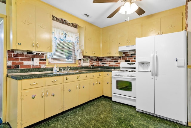 109 Rahway Rd, Goose Creek, SC 29445 - kitchen with white appliances, under cabinet range hood, cream cabinetry, dark floors, and dark countertops