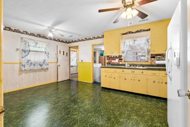 109 Rahway Rd, Goose Creek, SC 29445 - kitchen with ceiling fan, freestanding refrigerator, dark floors, dark countertops, and a wainscoted wall