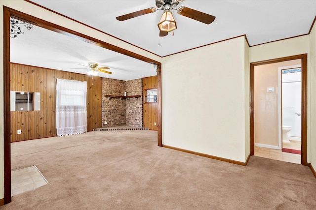 109 Rahway Rd, Goose Creek, SC 29445 - unfurnished living room featuring wooden walls, a ceiling fan, carpet, baseboards, and ornamental molding