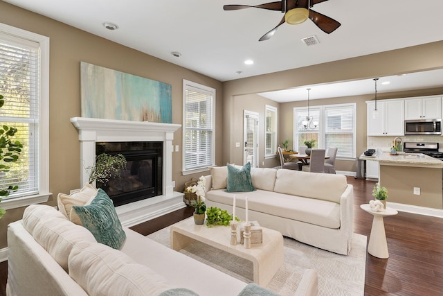 living room with sink, hardwood / wood-style floors, and ceiling fan