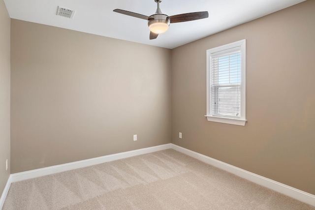 carpeted spare room featuring ceiling fan