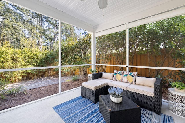 sunroom featuring ceiling fan