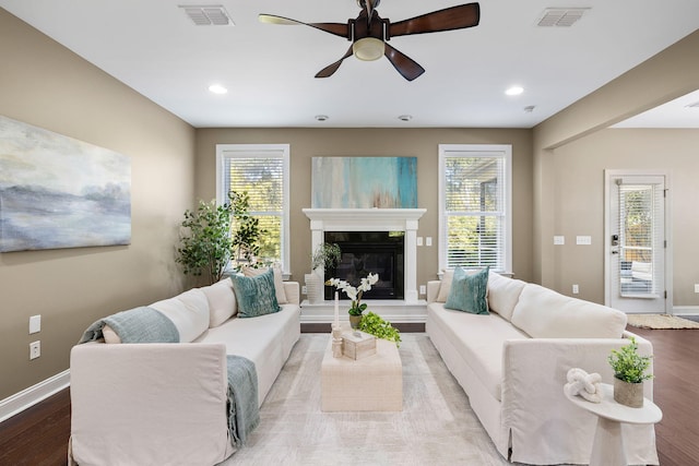 living room with ceiling fan, light hardwood / wood-style floors, and a healthy amount of sunlight