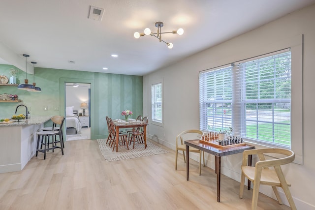 337 Price St, Goose Creek, SC 29445 - dining room featuring light wood-style floors, a chandelier, and baseboards
