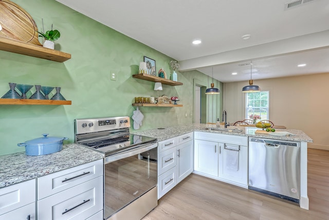 337 Price St, Goose Creek, SC 29445 - kitchen featuring open shelves, appliances with stainless steel finishes, a sink, light wood-style flooring, and white cabinets