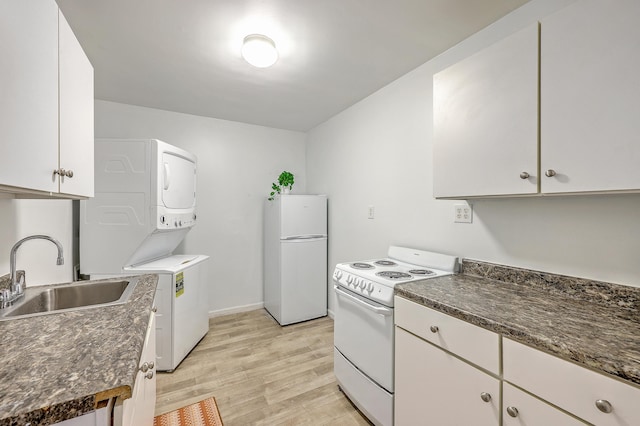 337 Price St, Goose Creek, SC 29445 - kitchen with fridge, white range with electric stovetop, stacked washer and clothes dryer, a sink, and light wood-style flooring