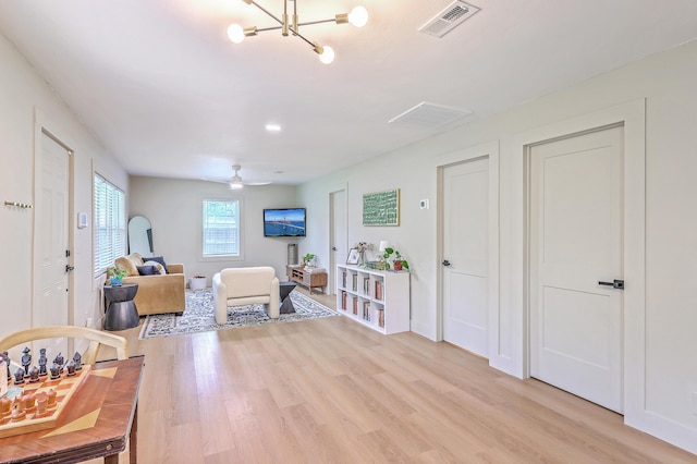 337 Price St, Goose Creek, SC 29445 - sitting room with light wood-style flooring and a chandelier