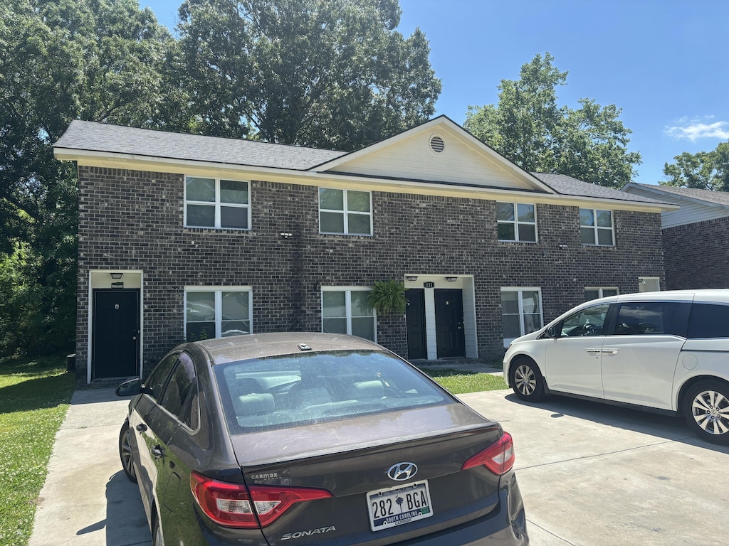 townhome / multi-family property featuring brick siding