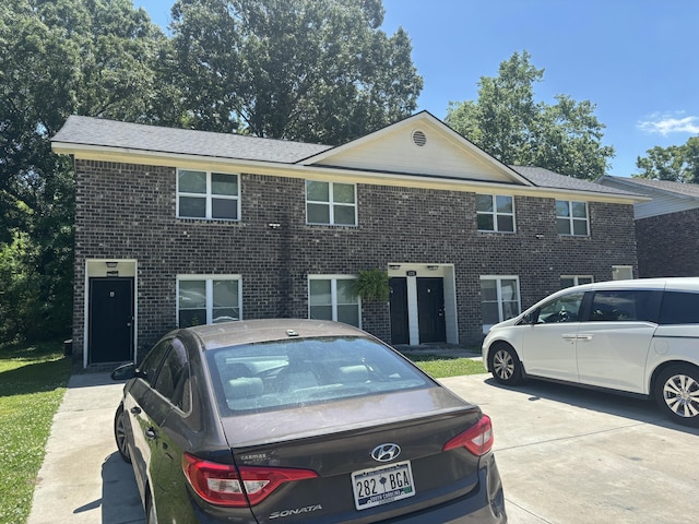 townhome / multi-family property featuring brick siding