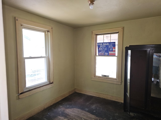 interior space featuring baseboards and a healthy amount of sunlight
