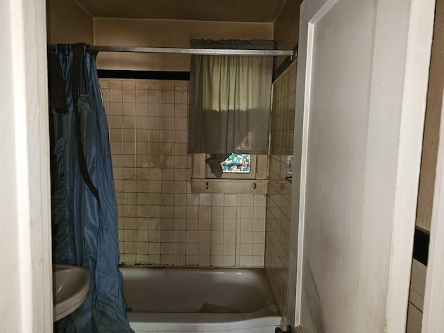 full bath with a sink and shower / tub combo