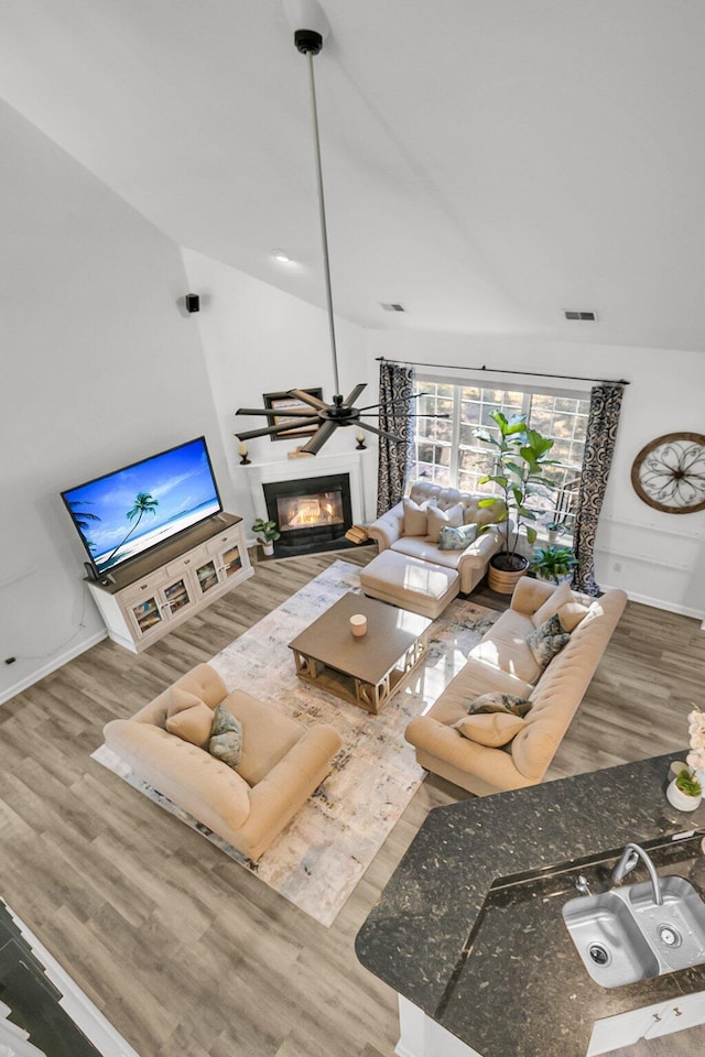 living room featuring lofted ceiling and wood-type flooring