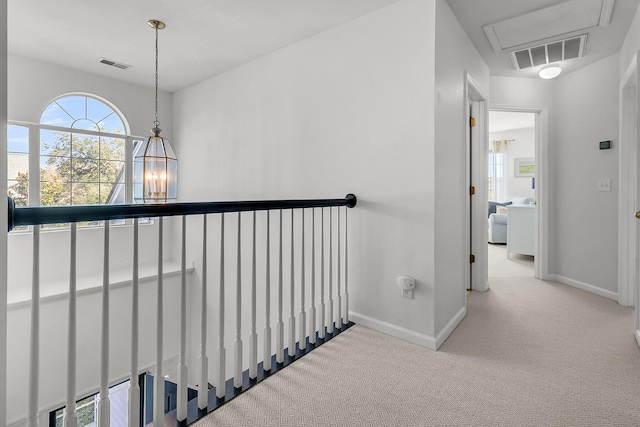 hall with light colored carpet