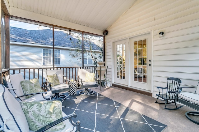 sunroom / solarium featuring vaulted ceiling