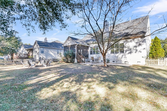 view of front of home with a patio, a sunroom, and a front lawn