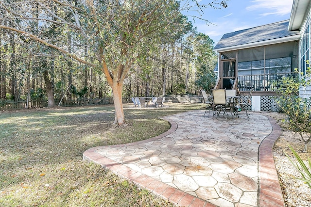 view of yard featuring a patio and a sunroom