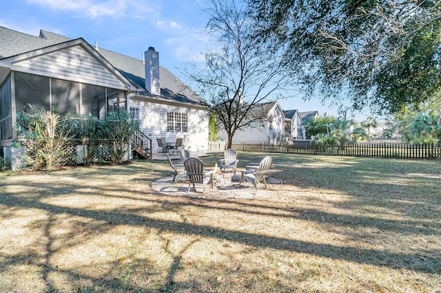 view of yard with a fire pit and a sunroom