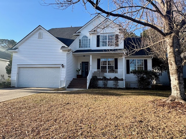 front of property featuring a garage, covered porch, and a front yard