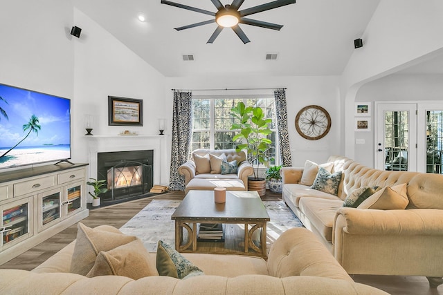 living room with ceiling fan, high vaulted ceiling, and light hardwood / wood-style floors