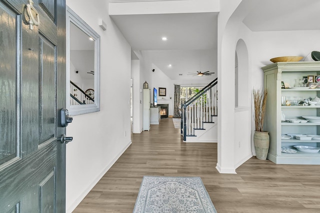 foyer with ceiling fan and light hardwood / wood-style flooring