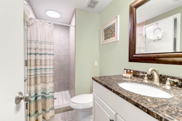 bathroom featuring walk in shower, vanity, toilet, and tile patterned floors