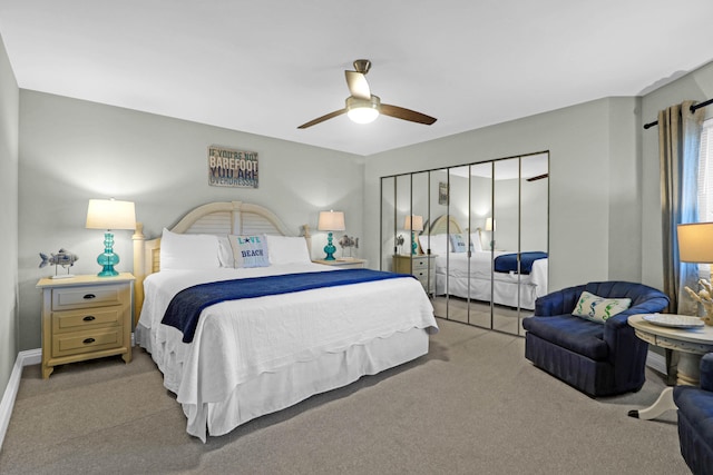 carpeted bedroom featuring a closet and ceiling fan