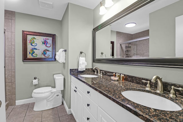 bathroom featuring tile patterned floors, walk in shower, vanity, and toilet