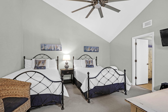 bedroom with ensuite bathroom, ceiling fan, light colored carpet, and high vaulted ceiling