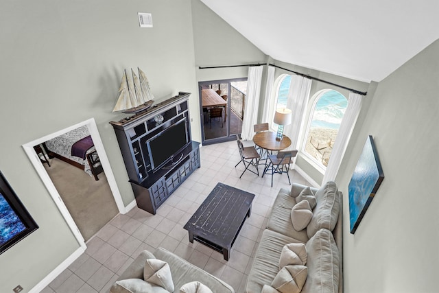 tiled living room with high vaulted ceiling