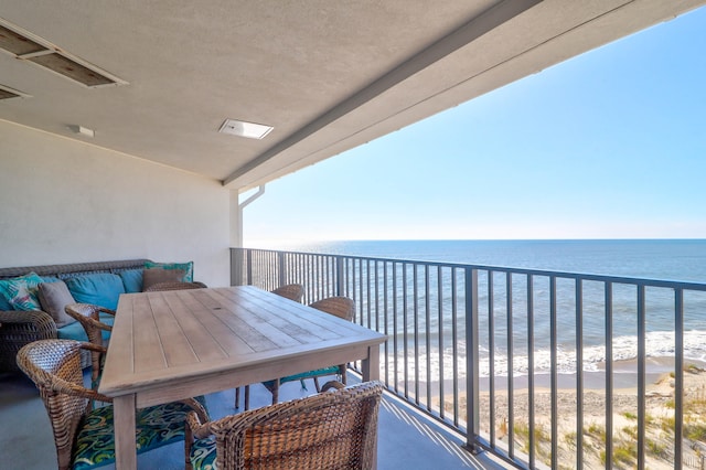 balcony with a beach view and a water view