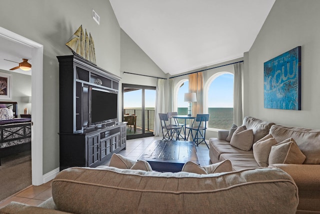 living room with high vaulted ceiling, ceiling fan, and light tile patterned floors