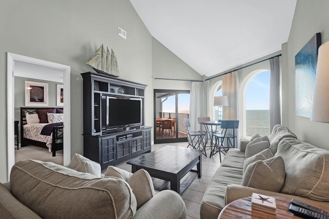 living room with light tile patterned floors and high vaulted ceiling