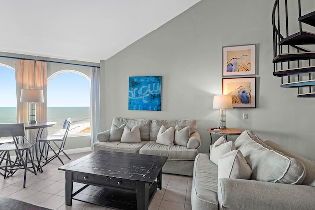 9002 Palmetto Dr Unit 512, Isle Of Palms, SC 29451 - living room featuring light tile patterned floors, lofted ceiling, a water view, stairs, and baseboards
