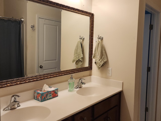 full bath with a sink and double vanity