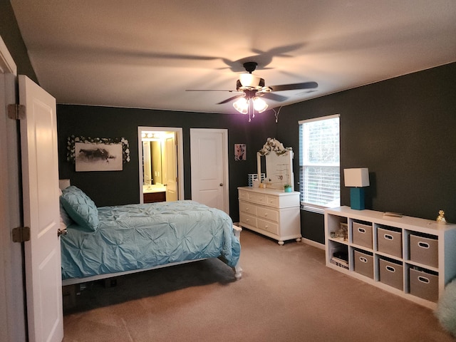 bedroom with a ceiling fan, carpet flooring, and ensuite bathroom