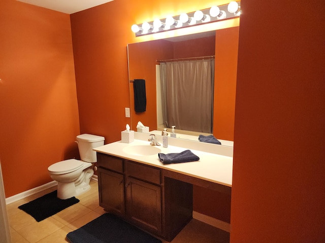 bathroom with a shower with curtain, toilet, vanity, tile patterned flooring, and baseboards