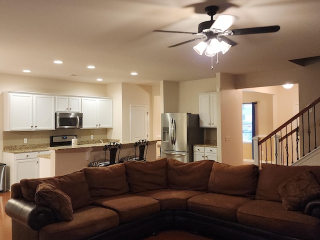 living room with stairs, ceiling fan, and recessed lighting