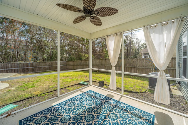 unfurnished sunroom with a ceiling fan