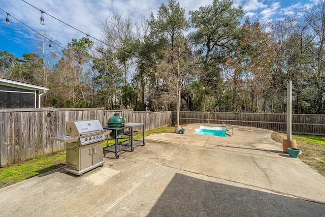 view of patio / terrace with a fenced backyard, a fenced in pool, and a grill