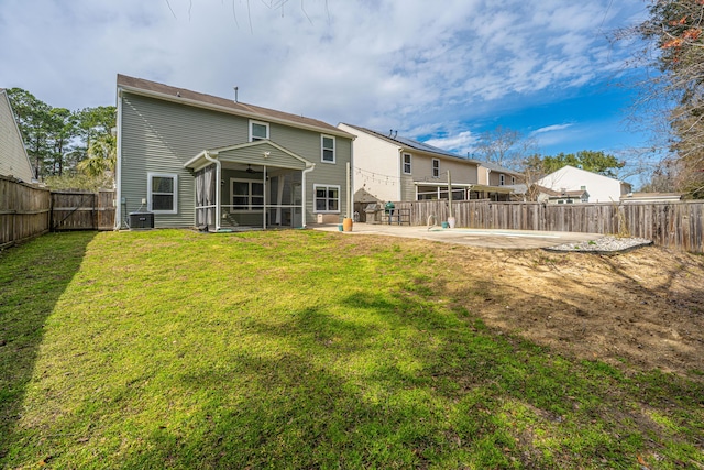 back of property with a sunroom, a fenced backyard, cooling unit, a yard, and a patio area