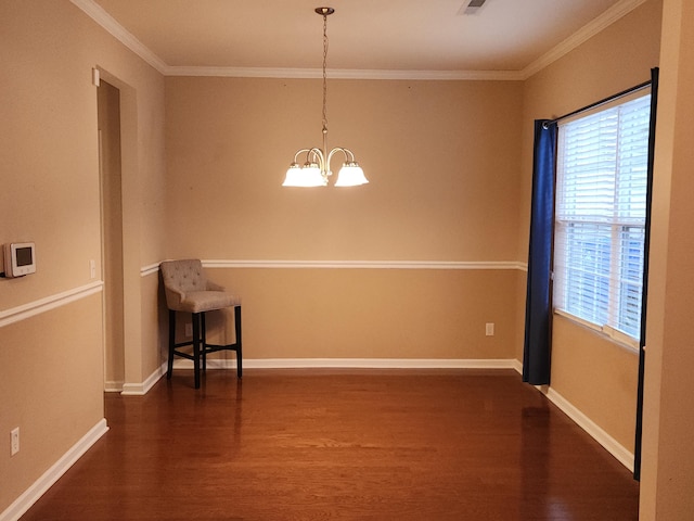 empty room with ornamental molding, dark wood-type flooring, a wealth of natural light, and an inviting chandelier