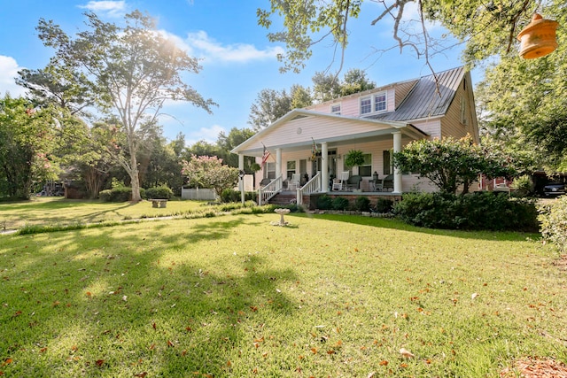 view of front of home with covered porch and a front lawn