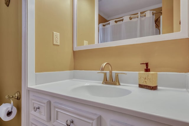 bathroom featuring crown molding and vanity