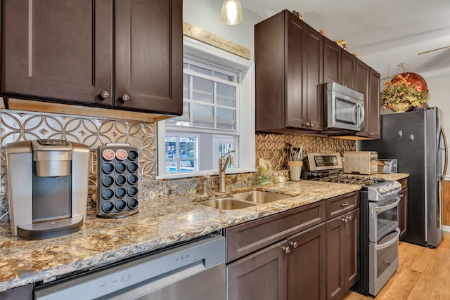 kitchen with backsplash, stainless steel appliances, ornamental molding, and sink