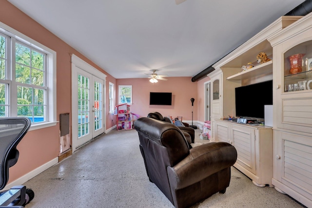 living room featuring ceiling fan and french doors