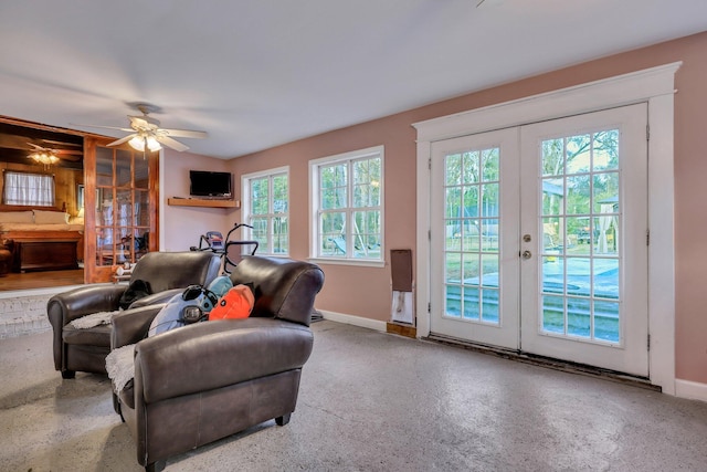 living room with french doors, ceiling fan, and a healthy amount of sunlight